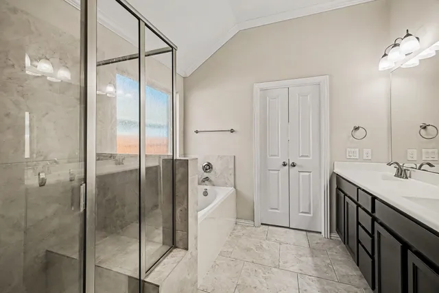a spacious bathroom with a shower and a sink