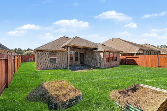 a view of a house with a backyard