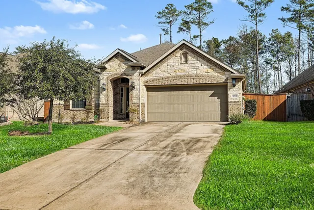 a front view of a house with yard and garage