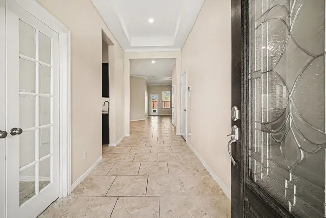 a view of a hallway with wooden floor and staircase