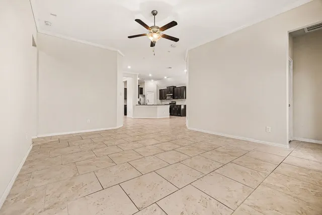a view of a kitchen with furniture and a fan