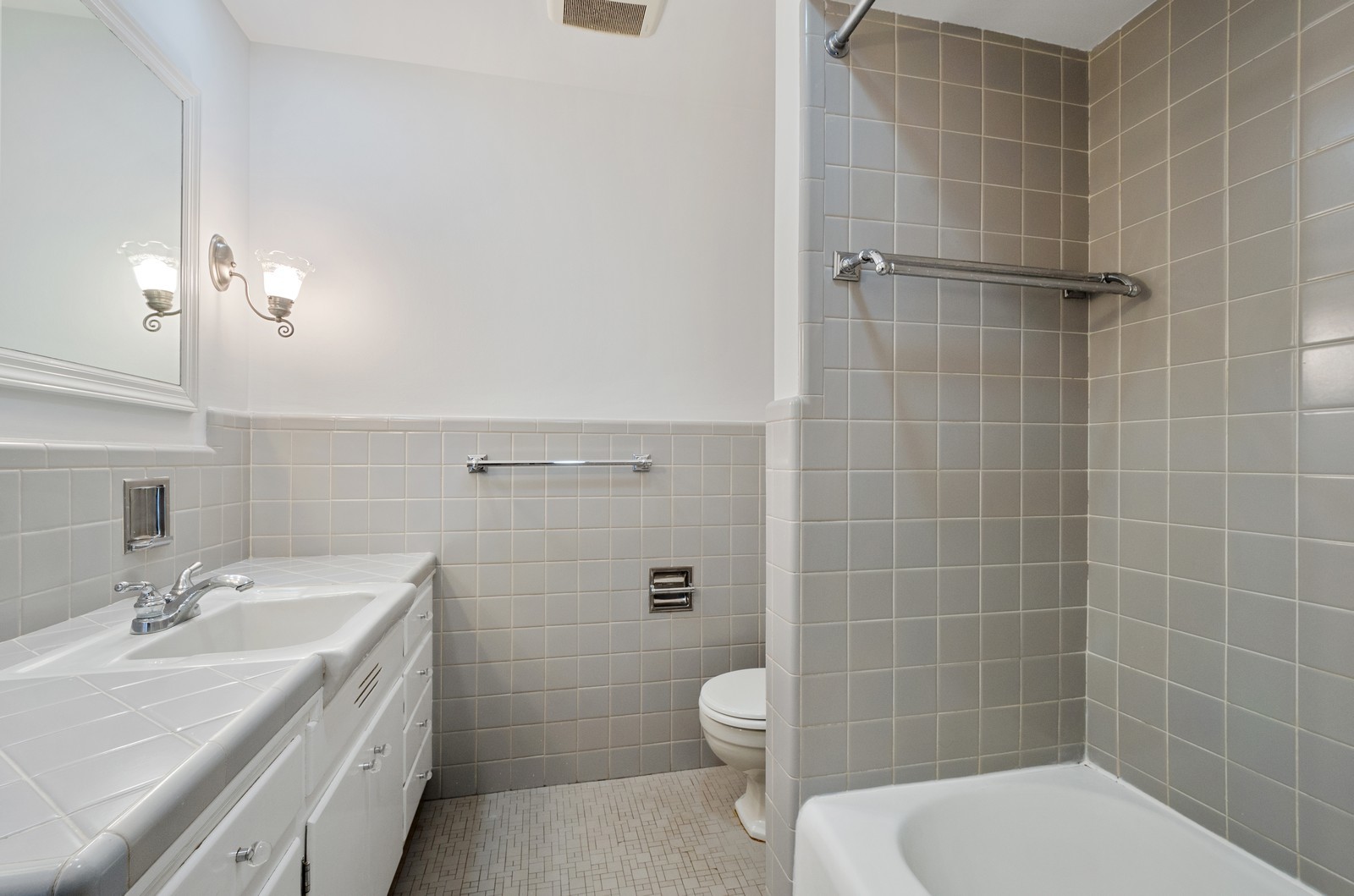 1347 Hackberry Lane Winnetka, IL 60093 - Photo 12 of 25 a bathroom with a granite countertop toilet a sink a shower and a mirror