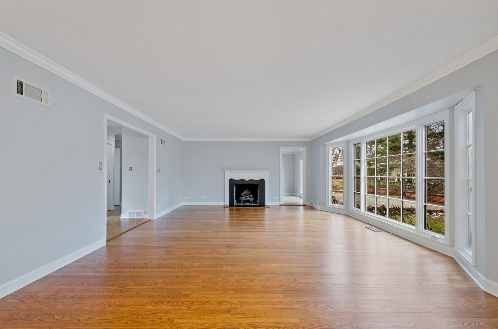 1347 Hackberry Lane Winnetka, IL 60093 - Photo 4 of 25 a view of an empty room with a fireplace and a window