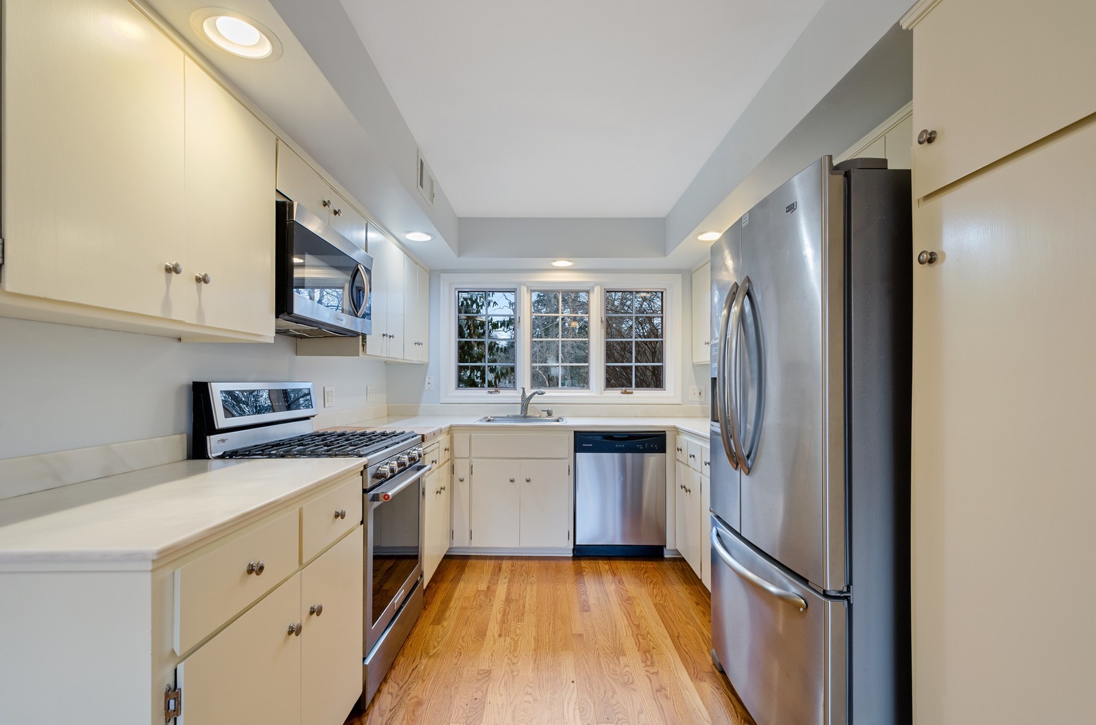 1347 Hackberry Lane Winnetka, IL 60093 - Photo 6 of 25 a kitchen with stainless steel appliances a refrigerator sink and stove
