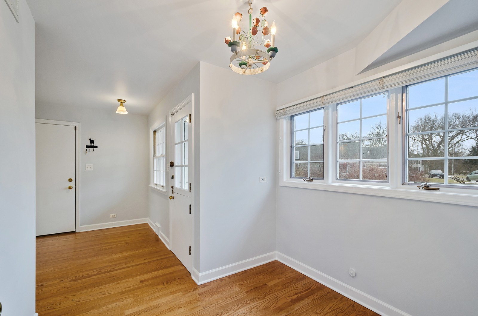 1347 Hackberry Lane Winnetka, IL 60093 - Photo 8 of 25 a view of an empty room with wooden floor and a window