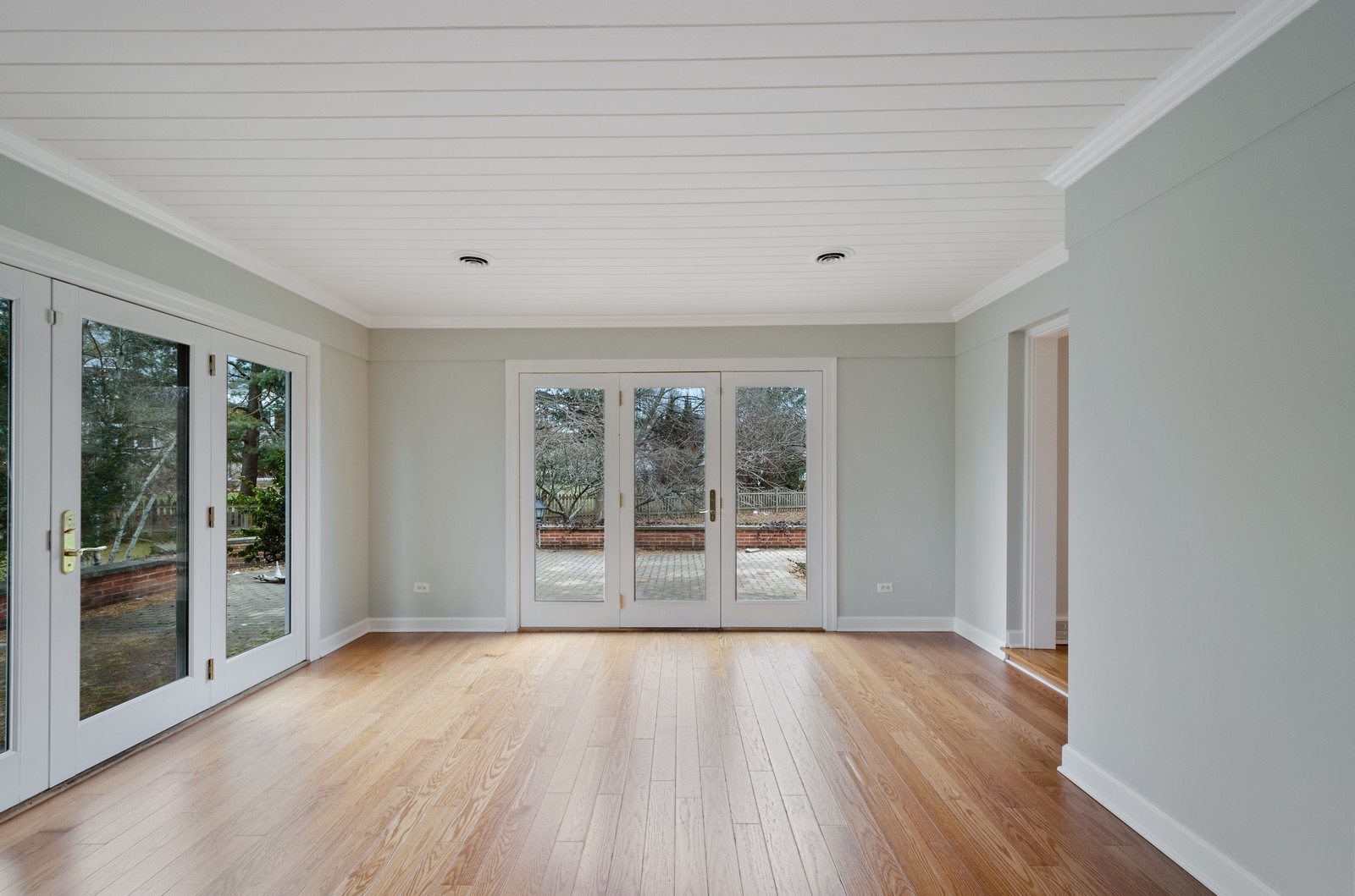 1347 Hackberry Lane Winnetka, IL 60093 - Photo 9 of 25 a view of an empty room with wooden floor and a window