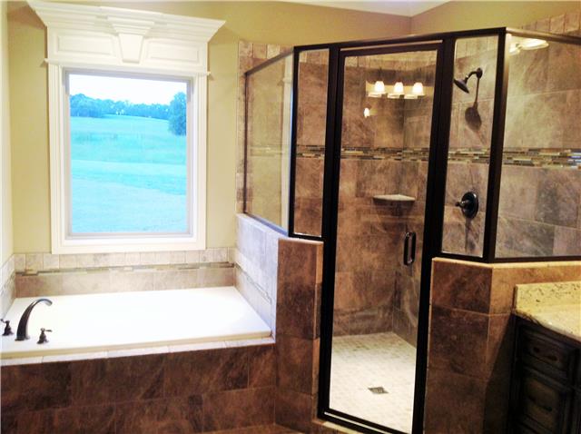 821 Double Log Cabin Road Lebanon, TN 37087 - Photo 10 of 16 a bathroom with a bathtub and a shower