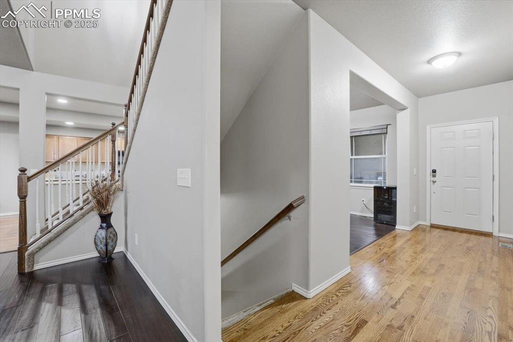2374 Cinnabar Road Colorado Springs, CO 80921 - Photo 22 of 50 The stair well to the basement level is off the entry. The stairs going to the second story are off the living room.