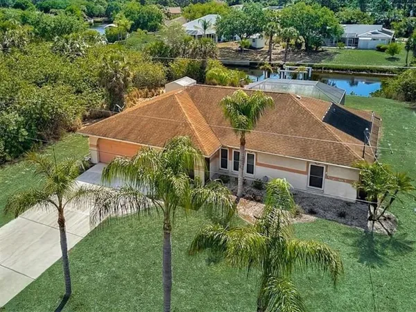 an aerial view of a house with yard swimming pool and outdoor seating