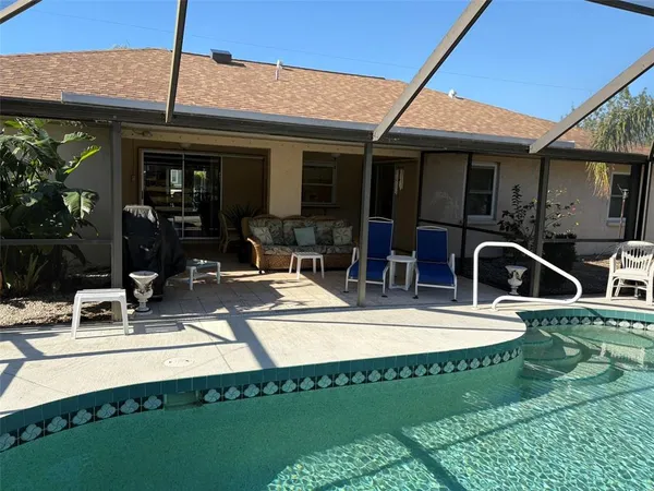 a view of a house with patio and a swimming pool