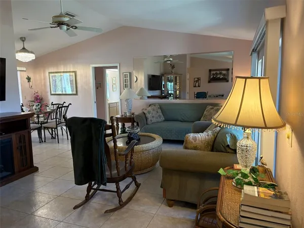 a living room with furniture a lamp and a chandelier