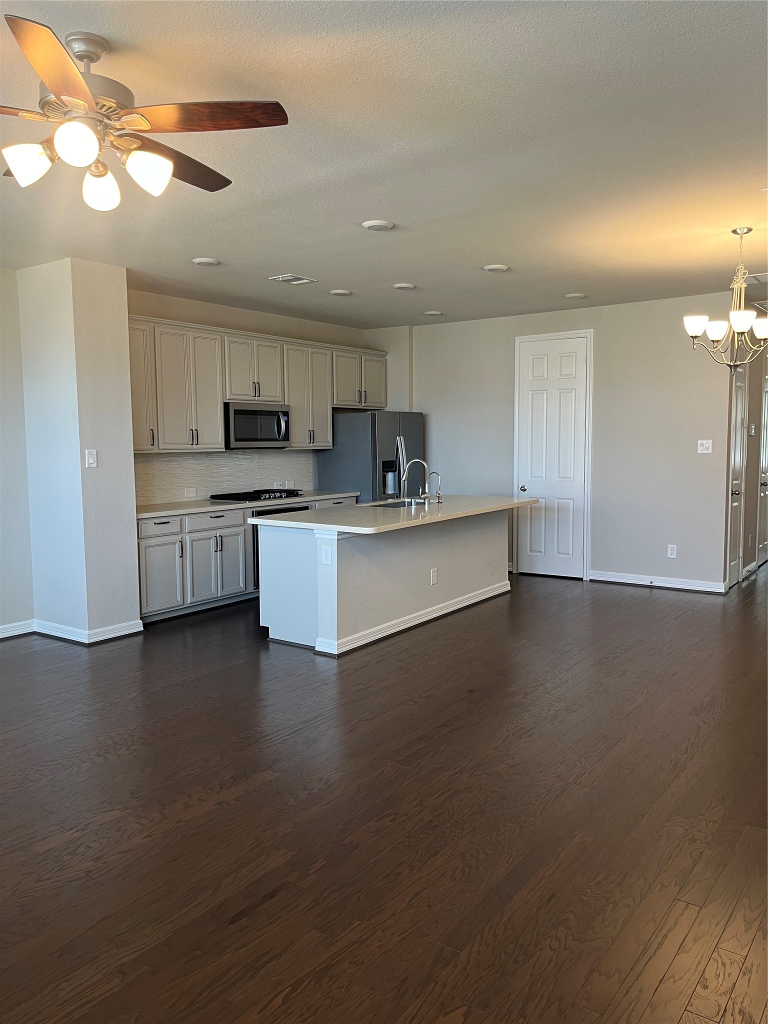 9452 Caddo Ridge Lane Cypress, TX 77433 - Photo 18 of 35 a kitchen with stainless steel appliances granite countertop a stove top oven a sink a counter space and cabinets