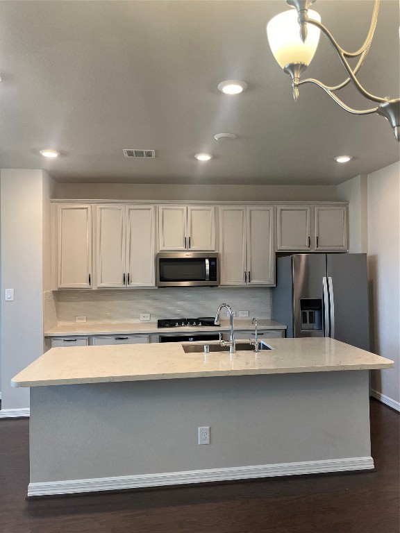 9452 Caddo Ridge Lane Cypress, TX 77433 - Photo 19 of 35 a kitchen with stainless steel appliances granite countertop a sink a microwave a refrigerator and white cabinets