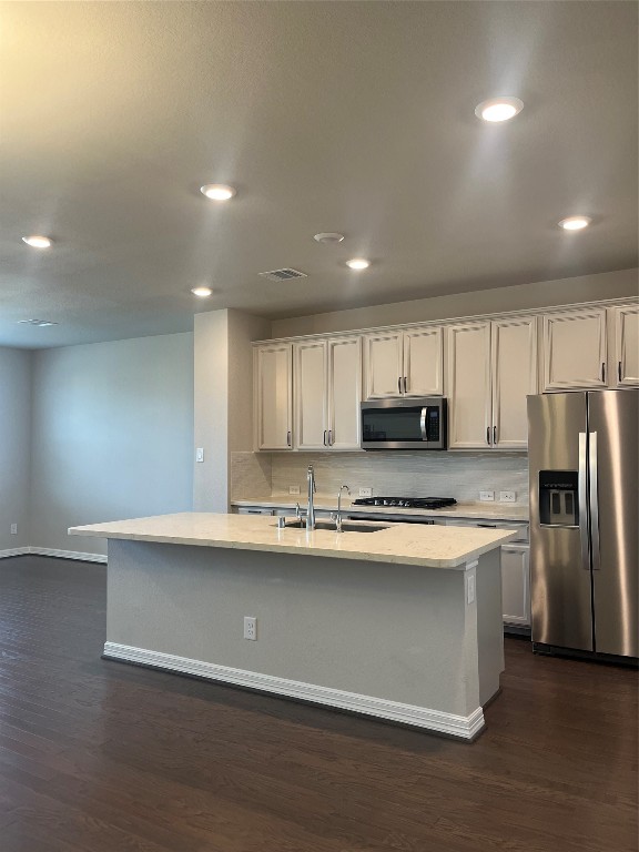 9452 Caddo Ridge Lane Cypress, TX 77433 - Photo 20 of 35 a kitchen with stainless steel appliances a sink a stove a refrigerator and cabinets