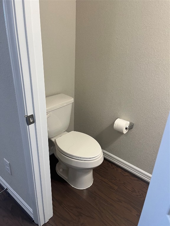 9452 Caddo Ridge Lane Cypress, TX 77433 - Photo 21 of 35 a white toilet sitting in a bathroom next to a sink