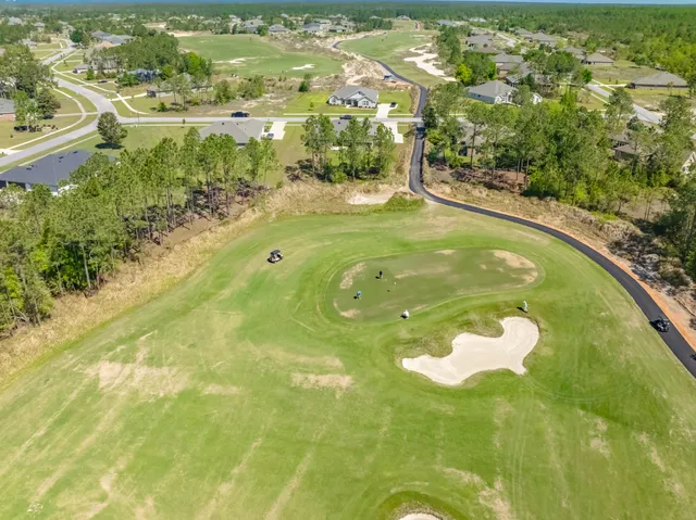 a kitchen with kitchen island granite countertop a sink refrigerator and cabinets