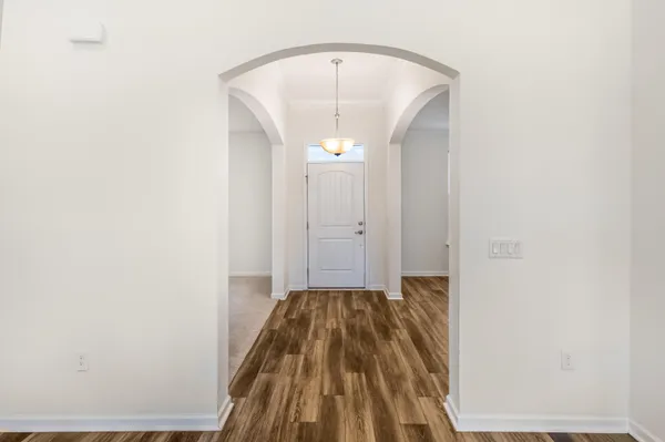 a view of a hallway with wooden floor