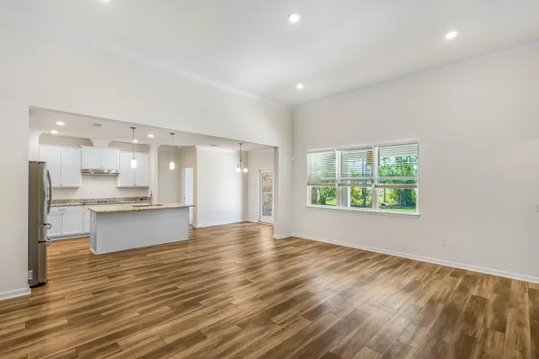 a view of large kitchen with granite countertop cabinets and wooden floor