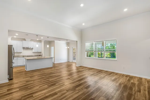 a view of large kitchen with granite countertop cabinets and wooden floor