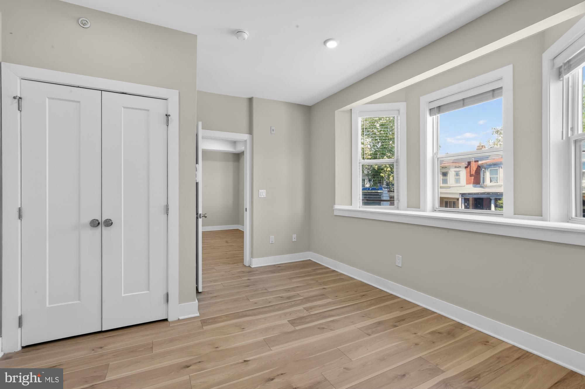 5230 Walnut Street, Unit 2F Philadelphia, PA 19139 - Photo 15 of 21 a view of an empty room with wooden floor and a window