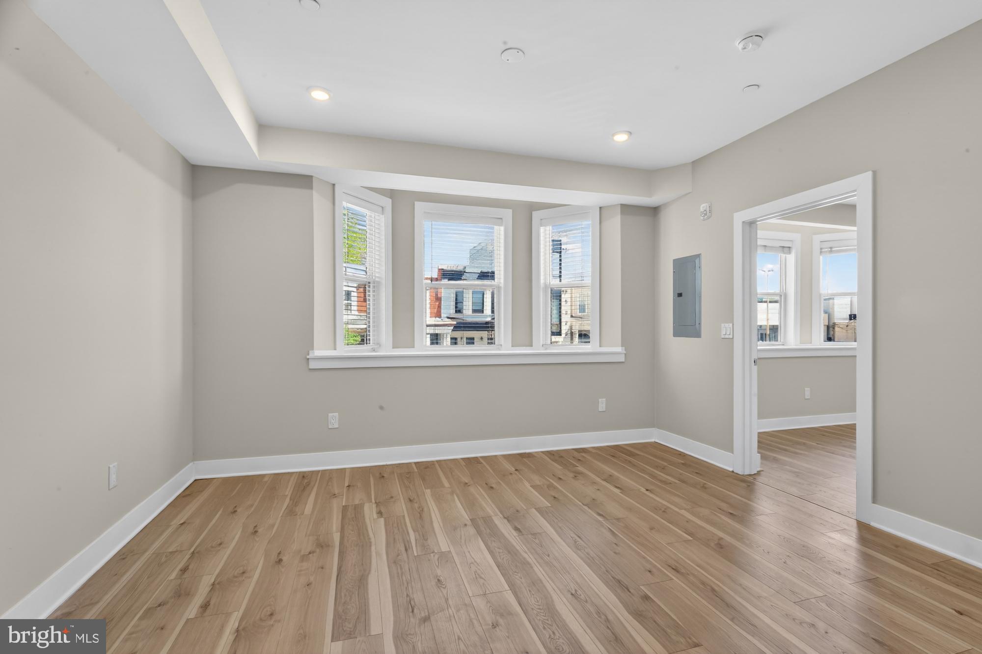 5230 Walnut Street, Unit 2F Philadelphia, PA 19139 - Photo 6 of 21 a view of empty room with wooden floor and fan
