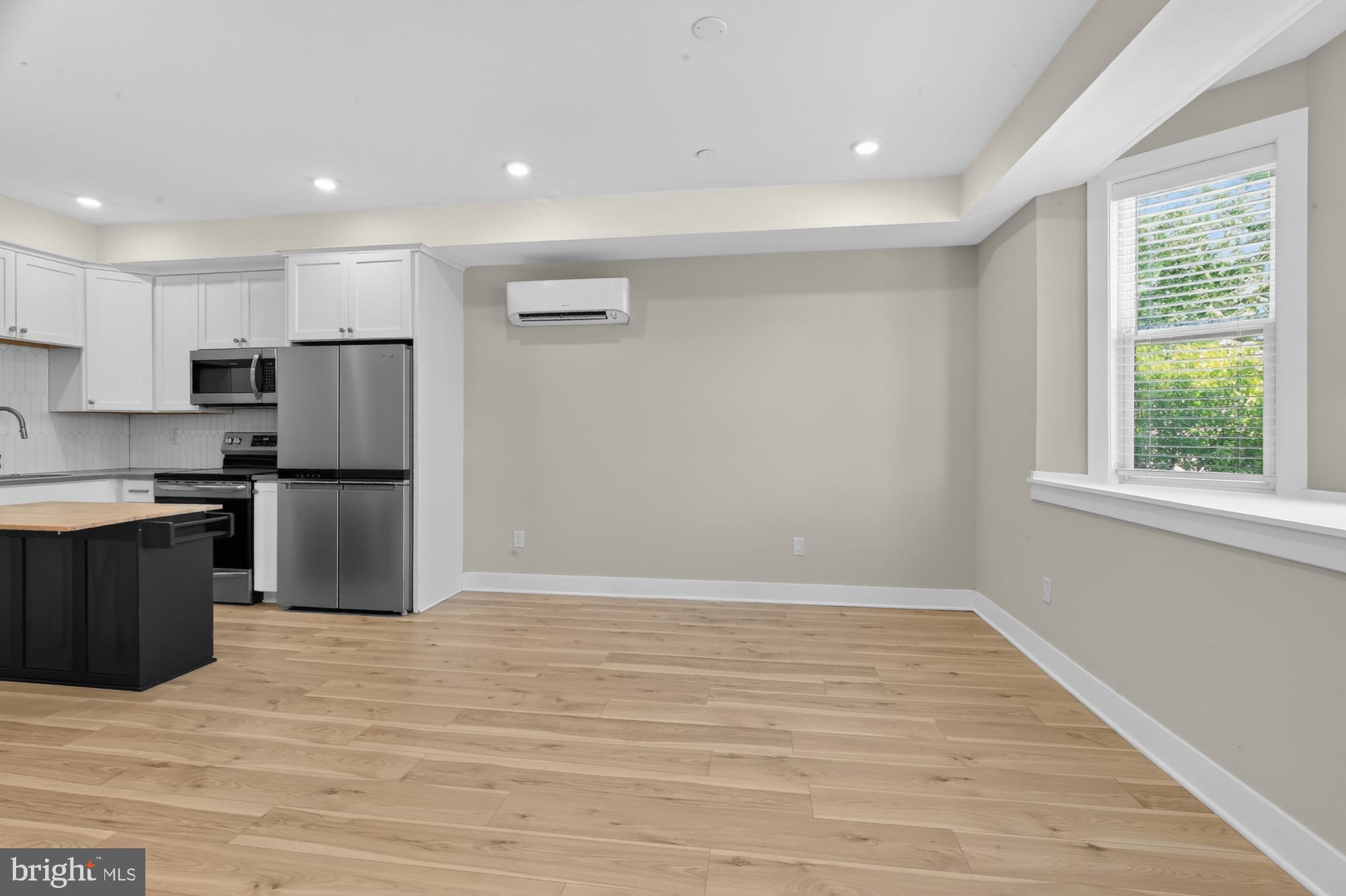 5230 Walnut Street, Unit 2F Philadelphia, PA 19139 - Photo 8 of 21 a kitchen with granite countertop a refrigerator and a stove top oven