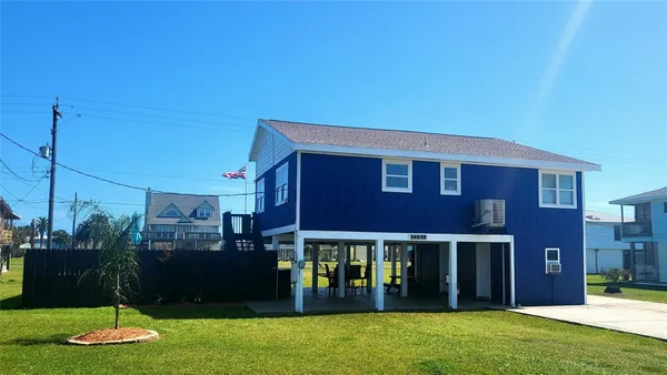 a view of a brick house with a yard
