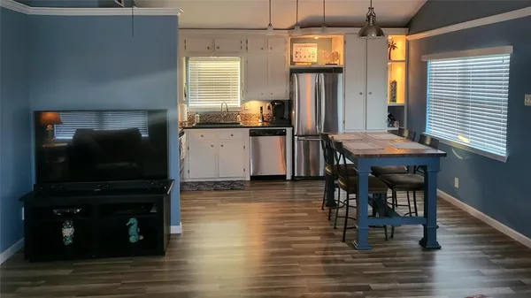 a dining room with furniture and wooden floor
