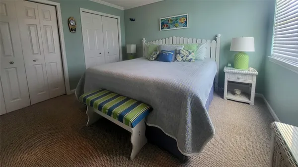 a bedroom with a bed chair and a window