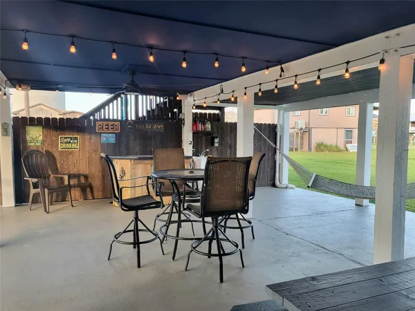 a view of a porch with furniture and a yard