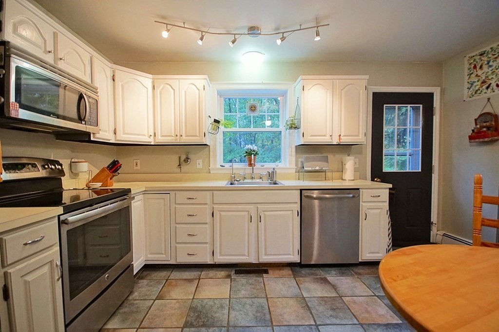 56 Boston Road Newbury, MA 01951 - Photo 12 of 31 a kitchen with cabinets appliances and a window