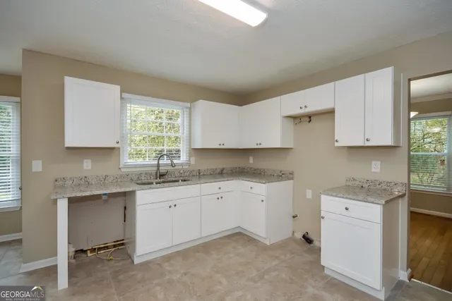 a kitchen that has a sink and a stove in it