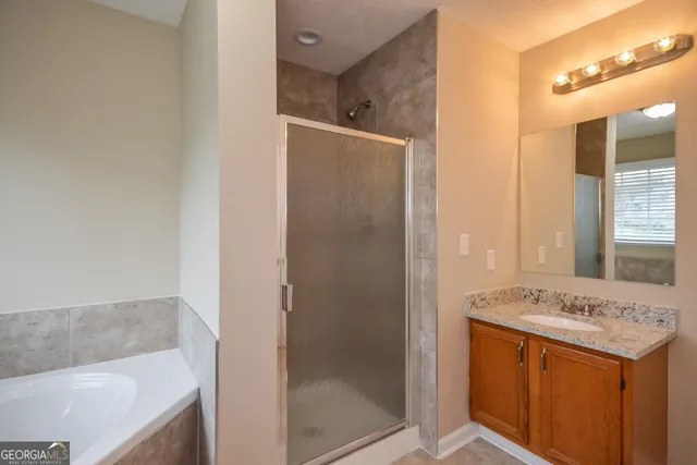 a bathroom with a granite countertop sink mirror and shower