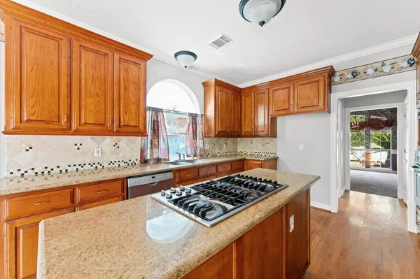 a kitchen with a stove a sink and a refrigerator