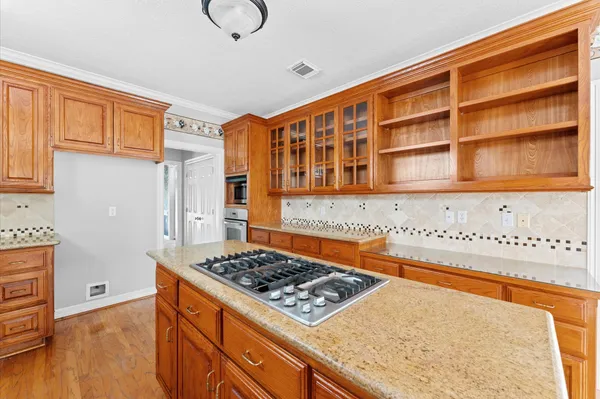a kitchen with stainless steel appliances granite countertop a stove and a refrigerator