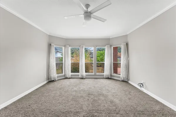 an empty room with windows and entrance
