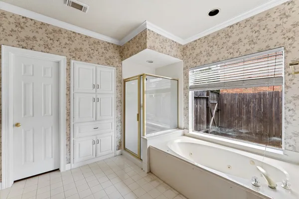 a spacious bathroom with a tub shower and sink