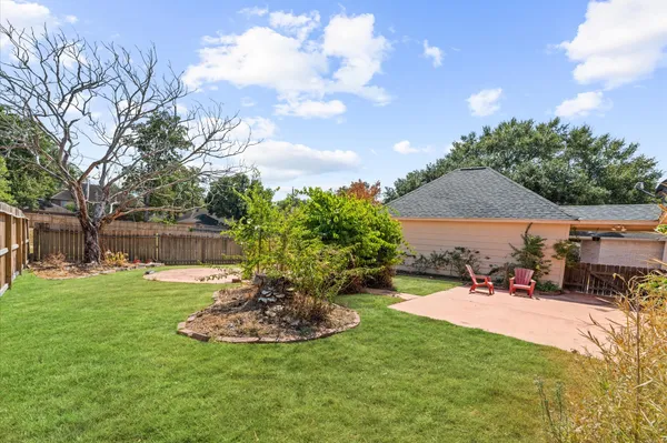 a view of a house with a backyard and porch