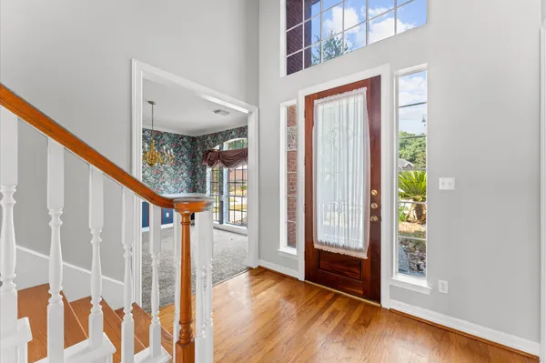 a view of entryway with wooden floor and stairs