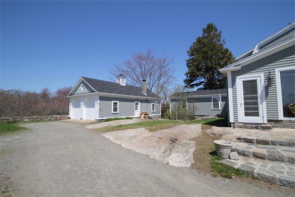 45 Links Road Gloucester, MA 01930 - Photo 7 of 17 a front view of a house with a dirt yard and a garage