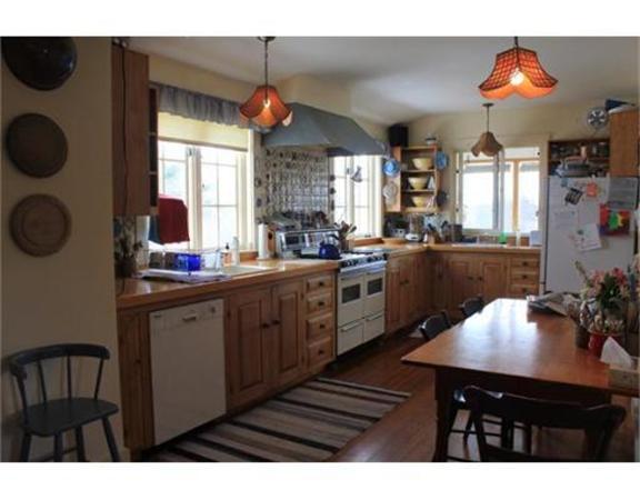 45 Links Road Gloucester, MA 01930 - Photo 10 of 17 a kitchen with a table chairs stove and cabinets