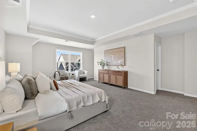 a bedroom with a white bed and white cabinets