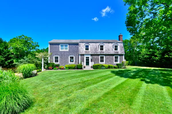 a view of a house with a flower garden