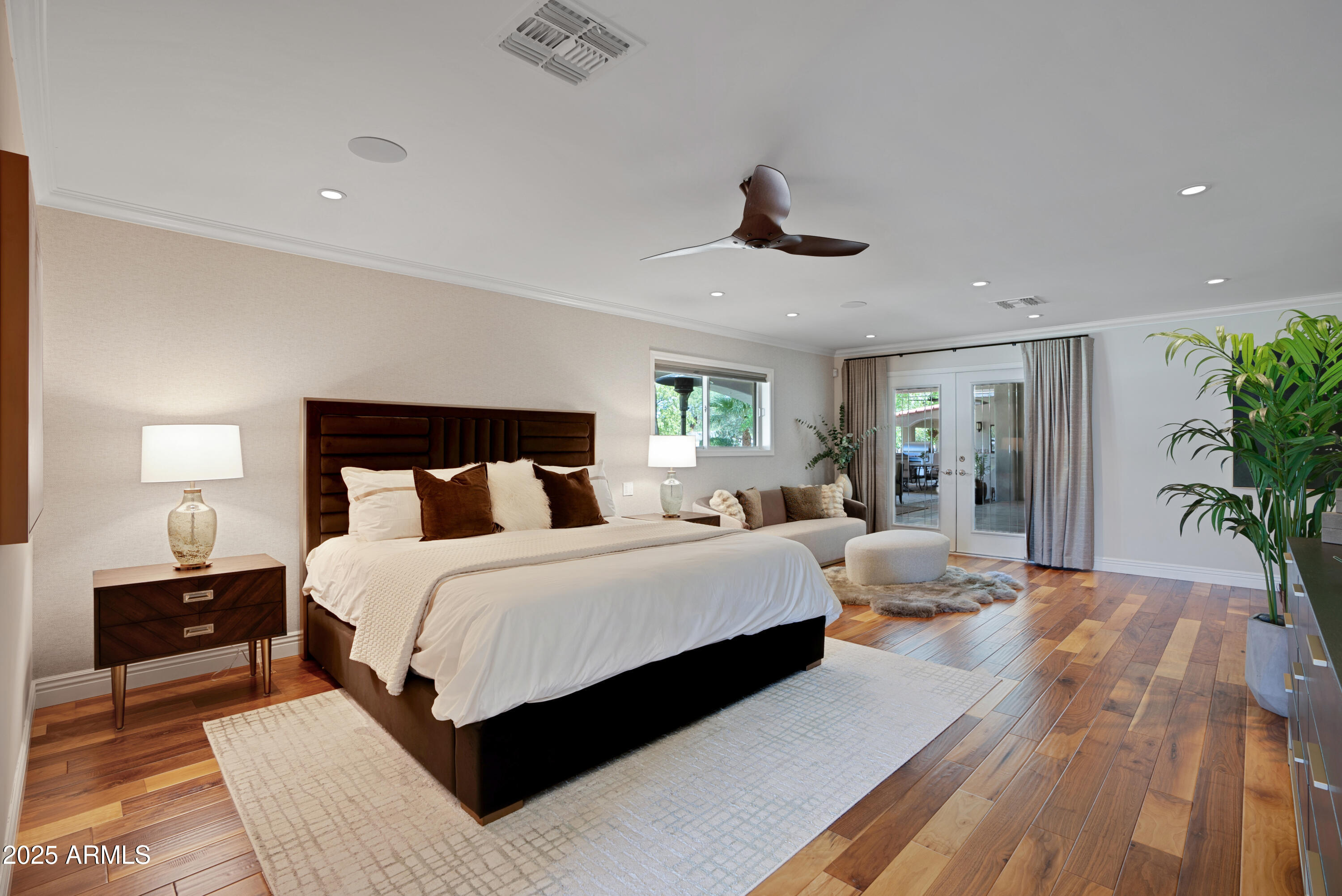 9236 North 52nd Place Paradise Valley, AZ 85253 - Photo 14 of 56 a bedroom with a large bed and a chandelier