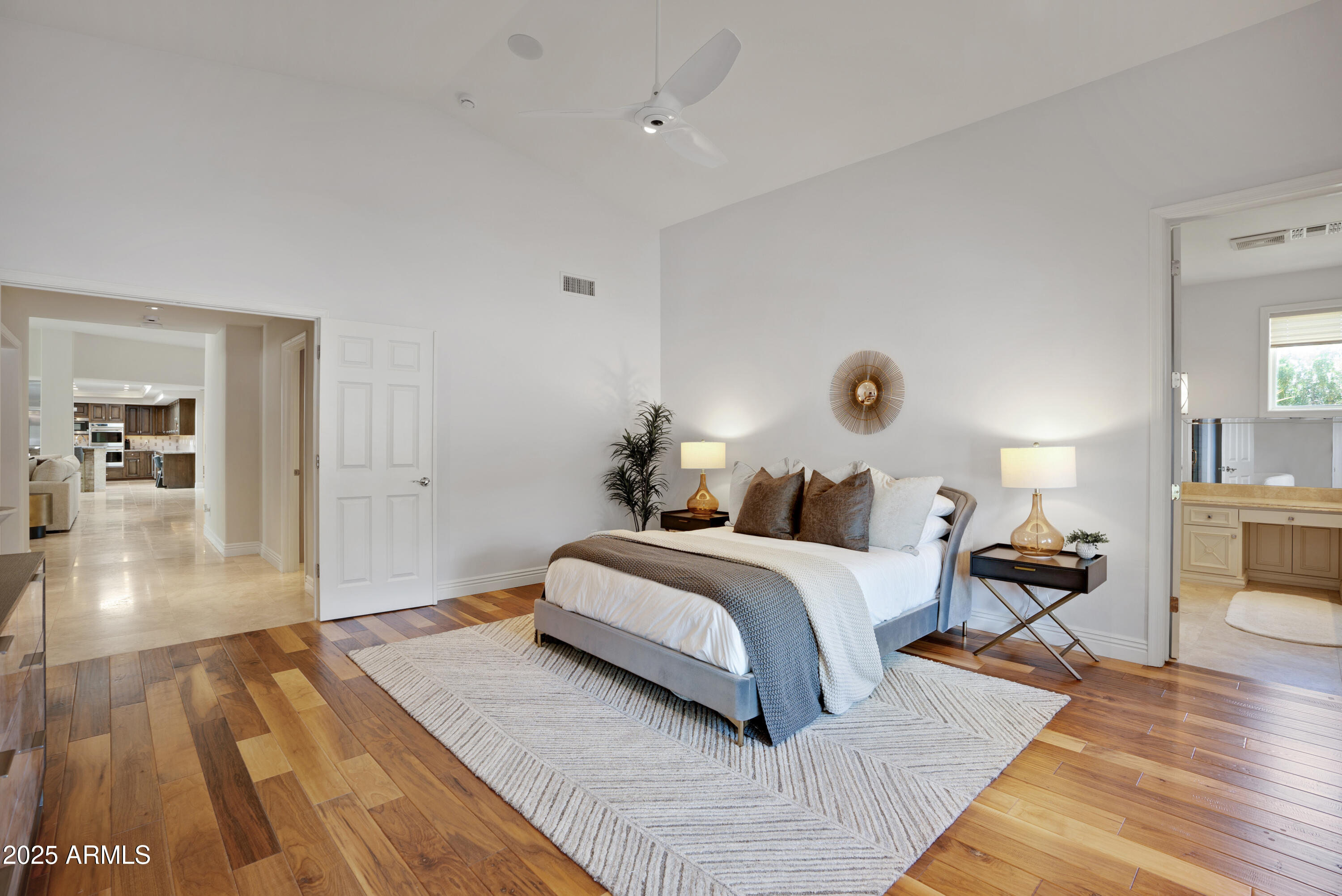 9236 North 52nd Place Paradise Valley, AZ 85253 - Photo 25 of 56 a spacious bedroom with a bed and wooden floor