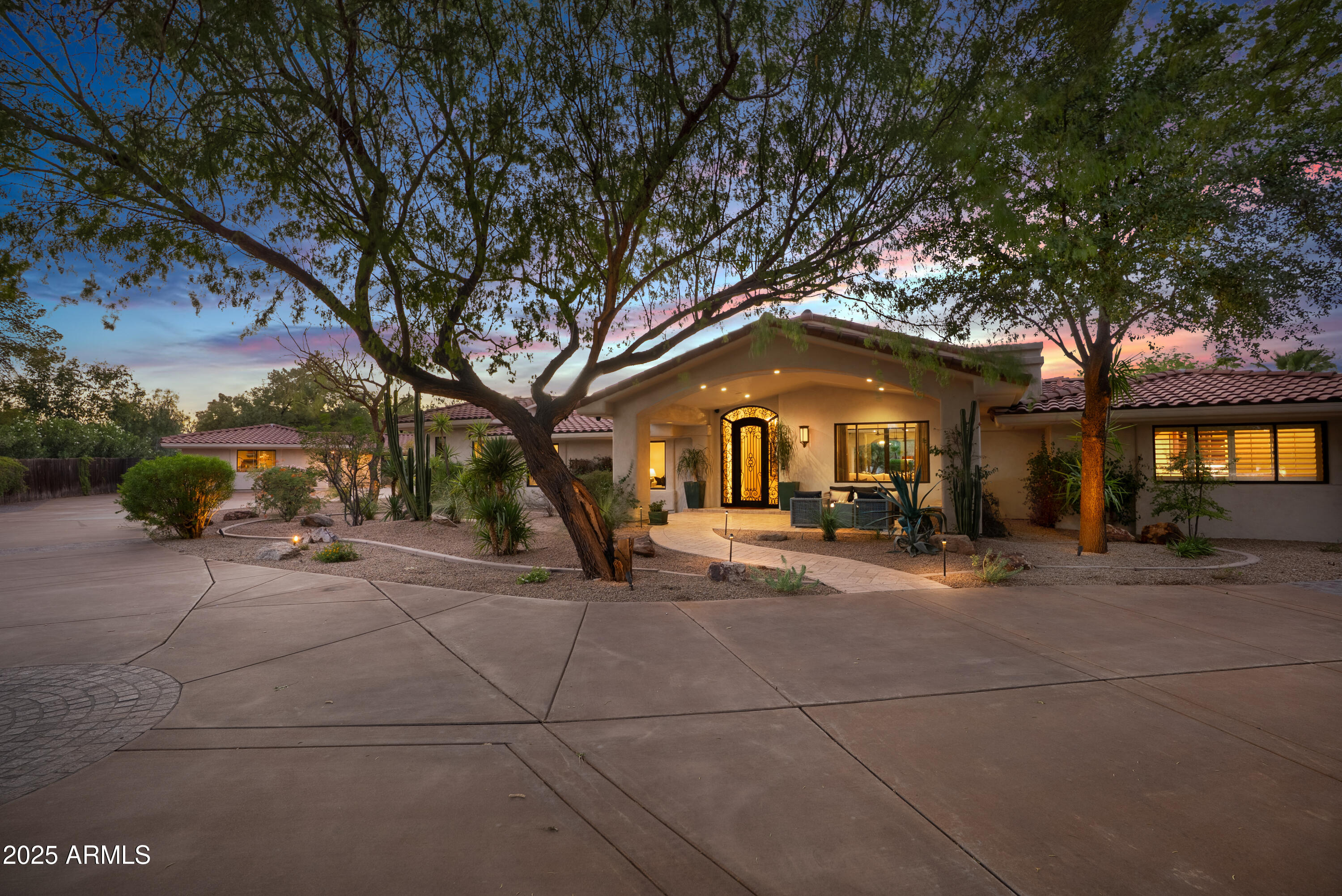 9236 North 52nd Place Paradise Valley, AZ 85253 - Photo 42 of 56 a front view of a house with garage and outdoor seating