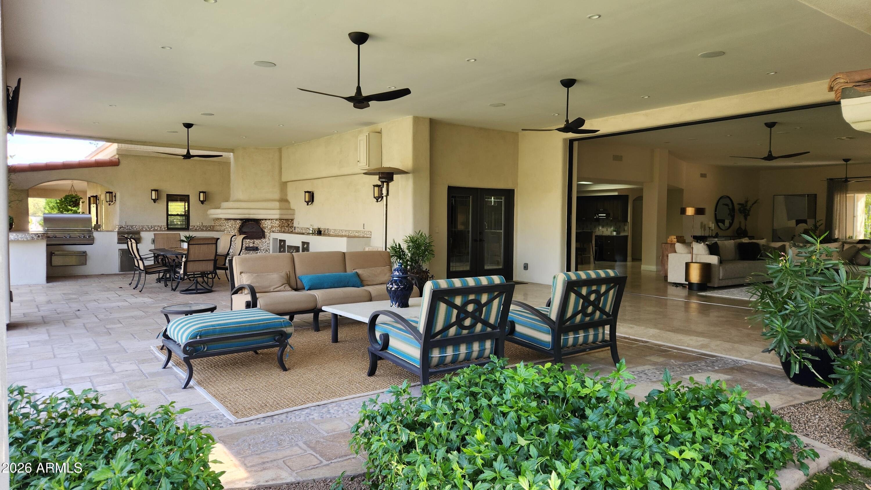 9236 North 52nd Place Paradise Valley, AZ 85253 - Photo 5 of 56 a living room with lots of furniture and a chandelier