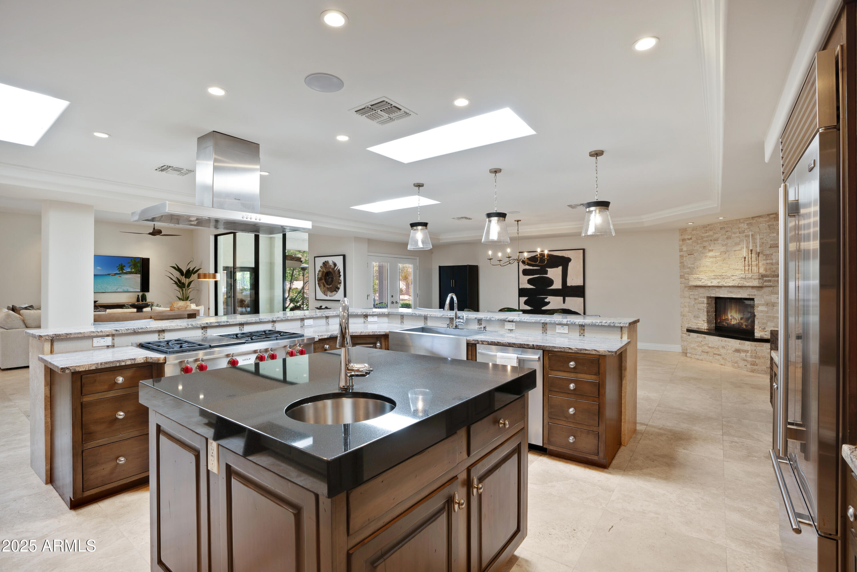 9236 North 52nd Place Paradise Valley, AZ 85253 - Photo 9 of 56 a kitchen with a stove a sink dishwasher and a refrigerator with the view of living room