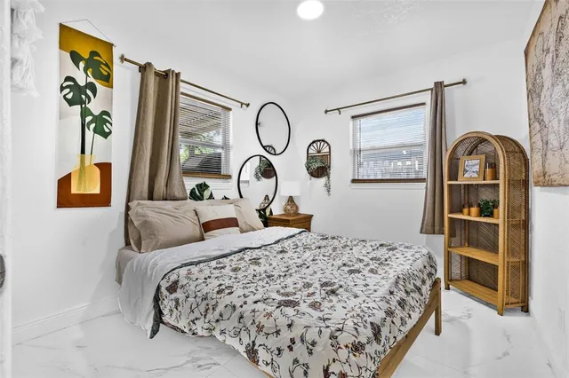 a bed sitting in a bedroom next to a window