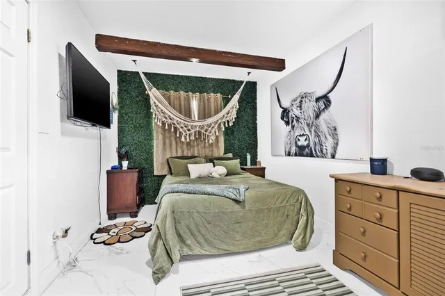 a bedroom with a bed and a mirror